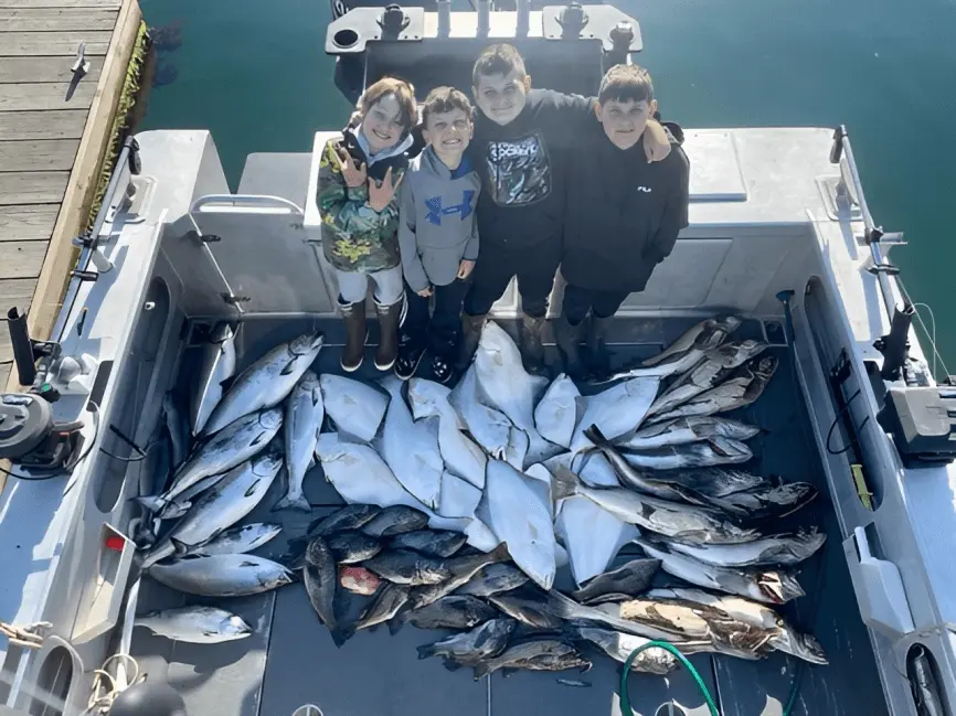 A group of people standing on top of a boat.